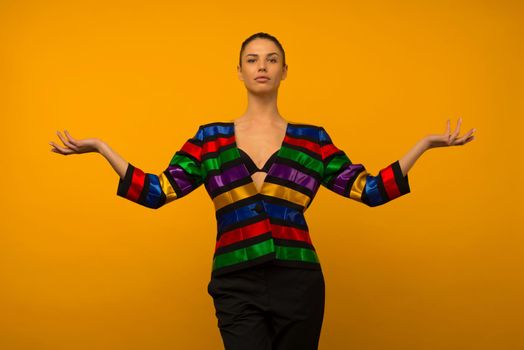 Young lesbian girl and an LGBT community representative posing in a flag coloring jacket LGBTQ shows something - image