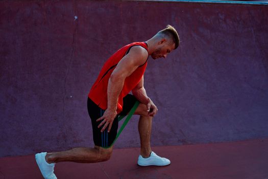 athletic man in red jersey workout exercise pumped up body. High quality photo