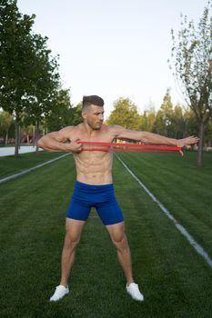 sporty man in blue shorts in the park exercise fitness. High quality photo