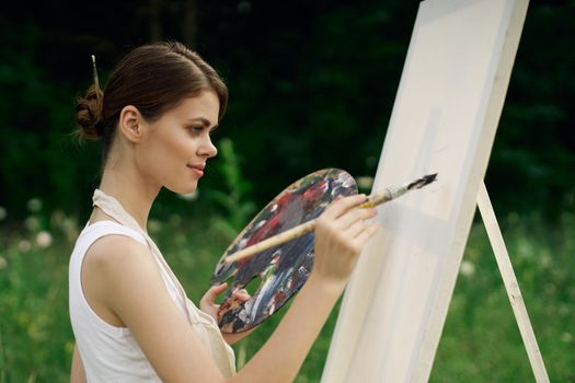 woman outdoors paint a picture landscape hobby creative. High quality photo