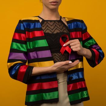 Woman Holds Red Ribbon to awareness world aids day Dec. 1 - image