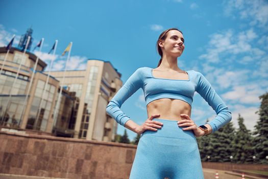 Beautiful fit young woman jogger is running outdoors