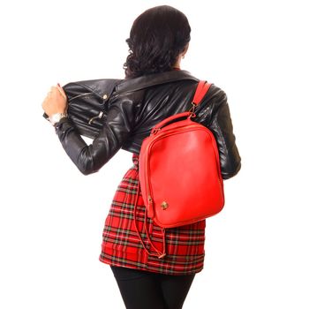 young woman back with red bag in black leather jacket white background