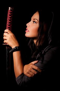 young woman in japanese anime cosplay, holding samurai sword.