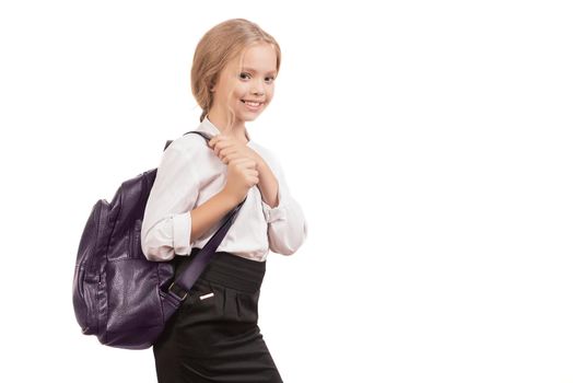 Young smiling happy school girl child with backpack in uniform isolated on a white background with copyspase