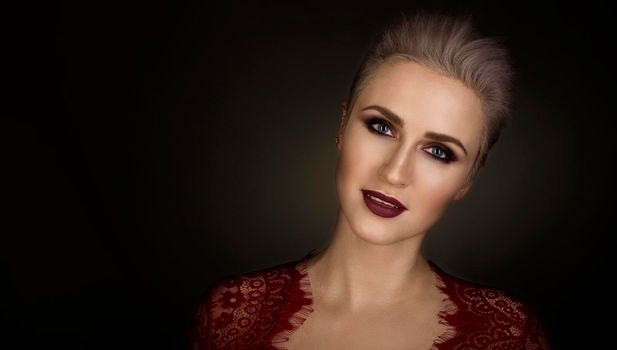 portrait of a beautiful blond woman with short hair and bright make-up.