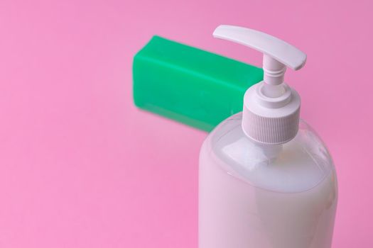 Hand antiseptic disinfection, soap bar on pink paper background. Close up.