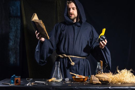 Portrait of a crazy medieval scientist working in his laboratory. Alchemist. Halloween.