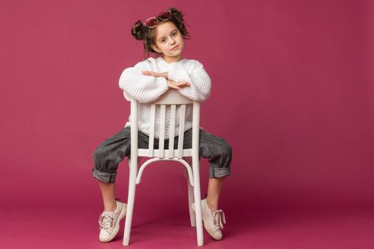 Photo of smiling little girl child isolated over pink background. Looking camera.