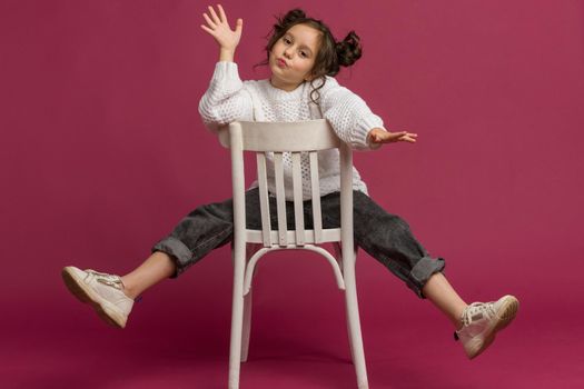 Photo of smiling little girl child isolated over pink background. Looking camera.