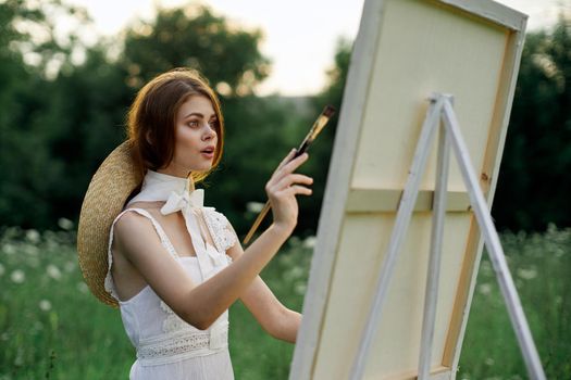 woman artist outdoors painting nature hobby art. High quality photo