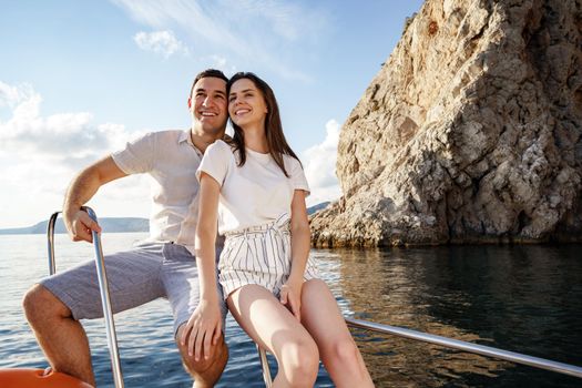 Happy couple in love on a yacht in summer on romantic vacation