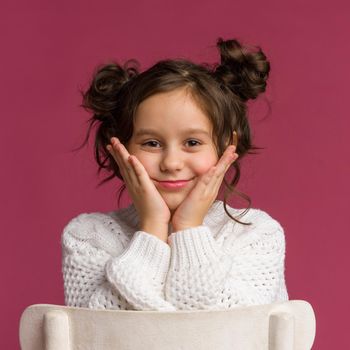 Photo of smiling little girl child isolated over pink background. Looking camera.