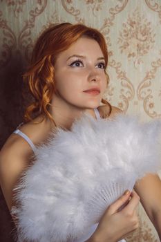 portrait Victorian redhair woman with white feather fan.