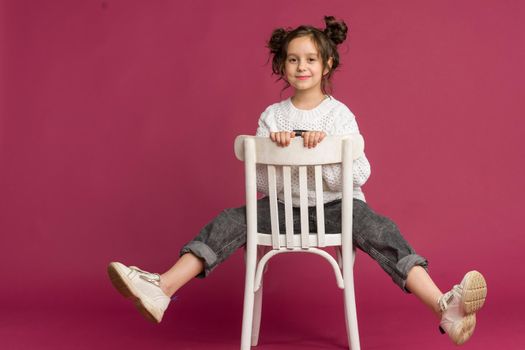 Photo of smiling little girl child isolated over pink background. Looking camera.