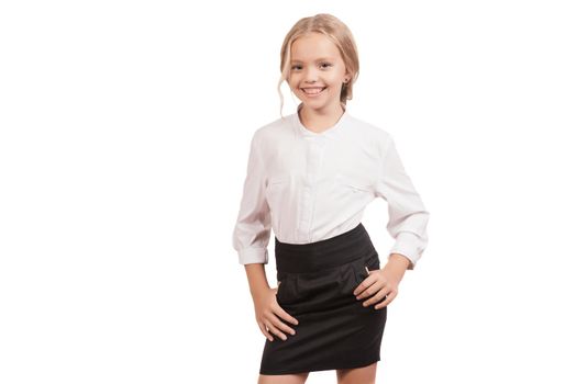 Lovely nine year old schoolgirl in a shirt and a skirt posing isolated on white