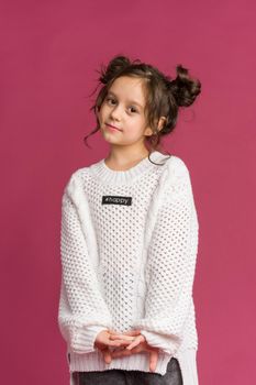 Photo of smiling little girl child isolated over pink background. Looking camera.