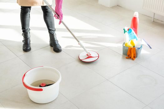 Spring cleaning woman cleaning floor with mop.