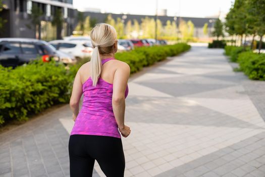 Fitness sport woman in fashion sportswear doing yoga fitness exercise in the street, outdoor sports, urban style