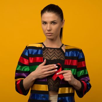 Woman Holds Red Ribbon to awareness world aids day Dec. 1 - image