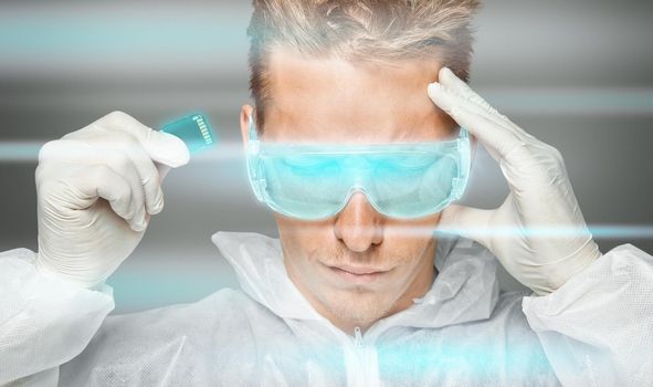Man in futuristic clothing holds memory card near his head