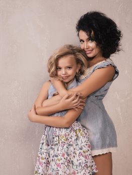 Caucasian cute mother hugging daughter , love and happy concept.