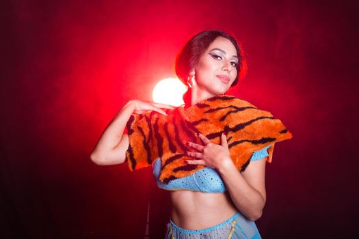 Girl doing selfie with tiger skin, crazy photos. Don't eco friendly lifestyle. Young woman takes pictures of herself in the phone. Life in social networks, narcissism, modern personality. Personality disorder