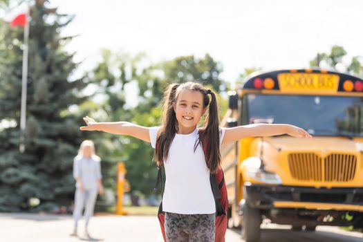 Mother taking her daughter to school, saying her goodbye for the day