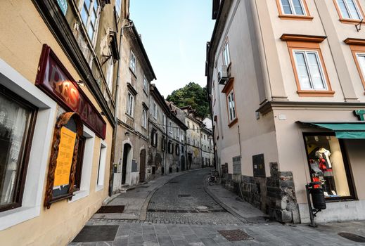 Ljubljana, Slovenia - May 20, 2018: Old buildings and narrow paved road in Ljubljana city center, Slovenia