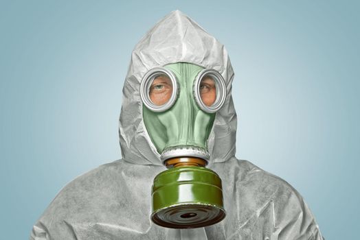 Male scientist in biohazard uniform and gas mask looks at camera
