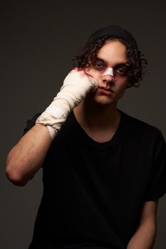 a fighter with a broken nose aggression conflict the dark background. High quality photo