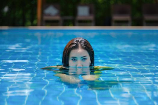 Beautiful southeast asia woman in pool relaxing