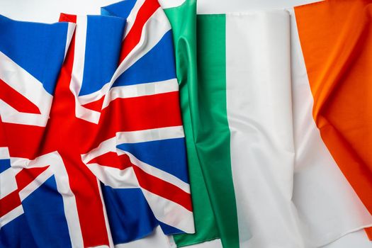 Flags of UK and Ireland folded together close up