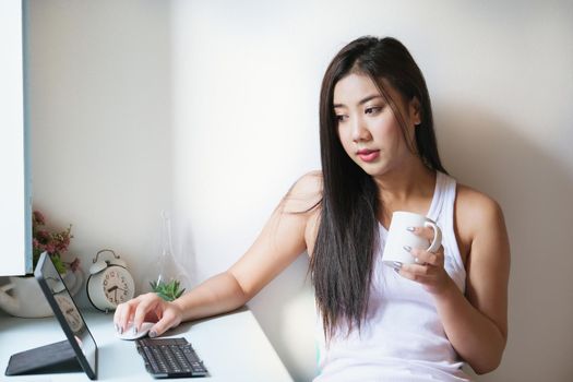 new normal, a businesswoman using tablet to work for a company Via the internet on your desk at home