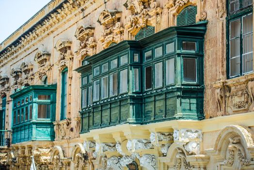 old ruined balcony in a street of historical center of Valletta in Malta