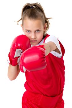 Preteen girl boxing with red gloves. Active girl wearing sportswear practicing punches against white background. Sporty child ready to fight, fitness workout concept