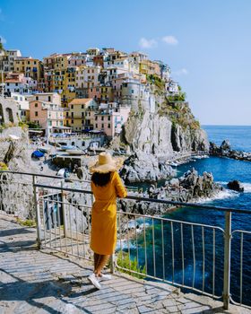 Colors of Italy Manarola village, Italy colorful coast Manarola Cinque Terre Italy, young Asian woman on vacation in Italy