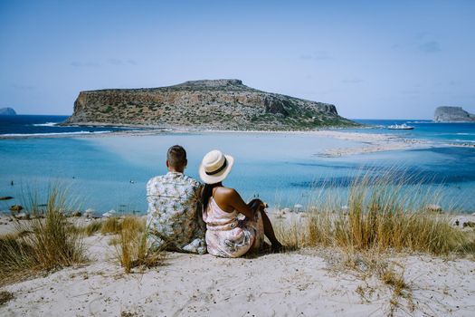 Crete Greece, Balos lagoon on Crete island, Greece. Tourists relax and bath in crystal clear water of Balos beach. Greece, couple men and woman visiting the beach