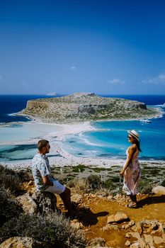 Crete Greece, Balos lagoon on Crete island, Greece. Tourists relax and bath in crystal clear water of Balos beach. Greece, couple men and woman visiting the beach