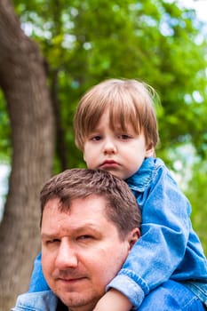 A male father spends time with his young son. Family walks in nature. The joy of being together.