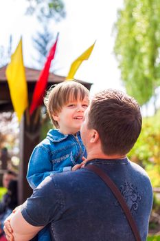 A male father spends time with his young son. Family walks in nature. The joy of being together.