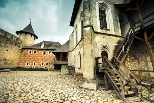inside yard with houses and wooden stairs of Khotyn Fortress