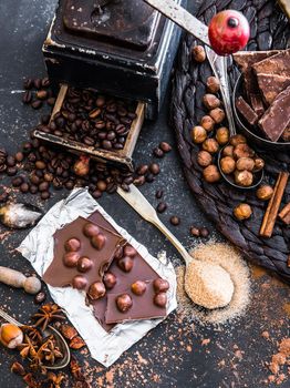 chocolate, cocoa and various spices on black table