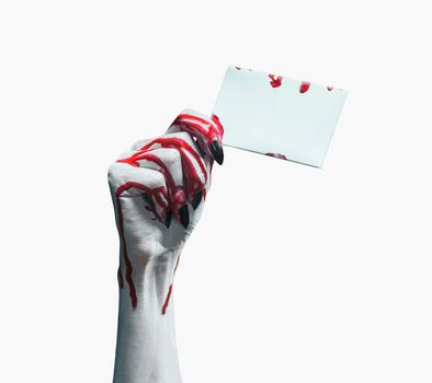 Vampire bloody hand holds empty card on white background, space for text. Halloween/horror theme