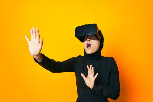 Muslim virtual reality glasses entertainment yellow background. High quality photo