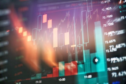Analysis business accounting on info sheets. Businessman hand working on analyzing investment charts for Gold market, Forex market and Trading market .