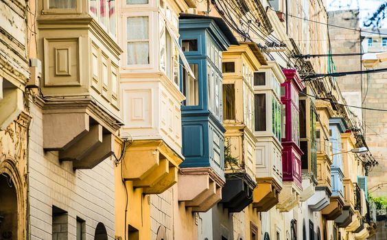 street with traditional balconies in historical center of Valletta in Malta