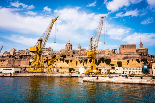 cranes and docks on the shore Cospicua near Valletta in Malta