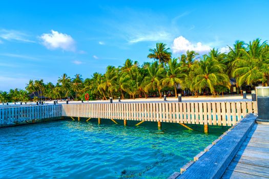 Water Villas,Bungalows and wooden bridge at Tropical beach in the Maldives at summer day.Tourism concept.
