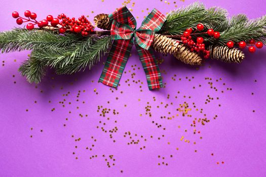 Christmas decor with sparkles of stars on a purple background. New year, holiday mood. copyspace, flat lay